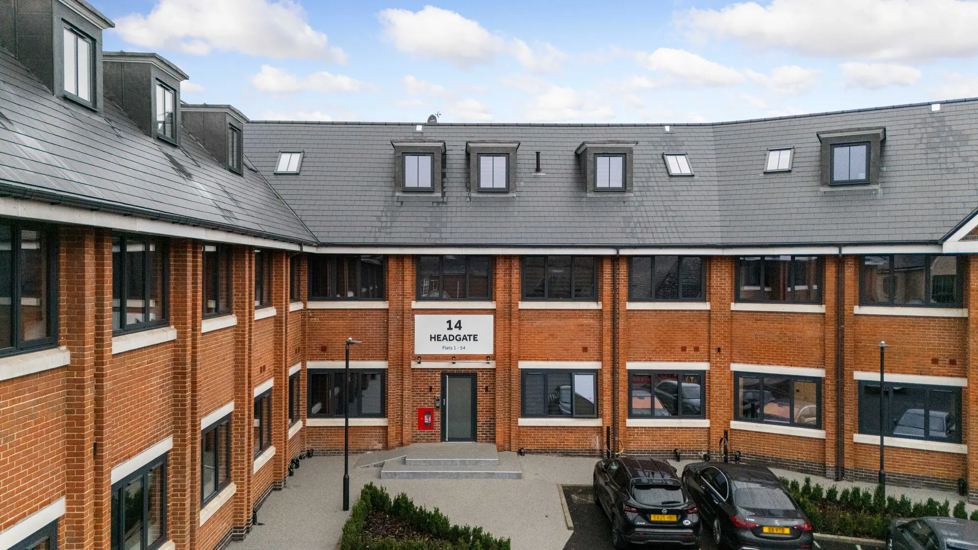 14 Headgate, Colchester: red-brick courtyard building with new dark grey aluminium windows